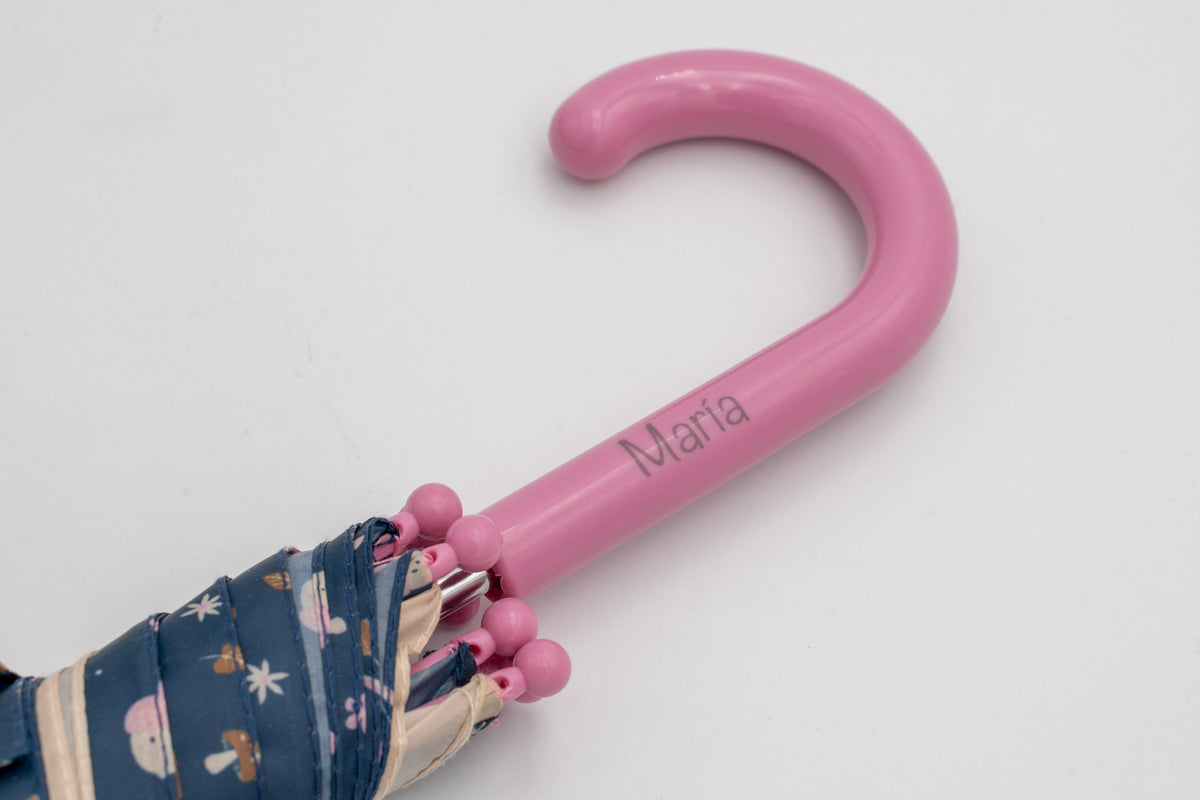 Pink children's umbrella handle with the name María printed in colour