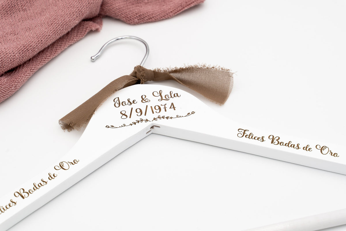 White hanger with the names José and Lola, the date 8/9/1974 and «Felices Bodas de Oro» engraved