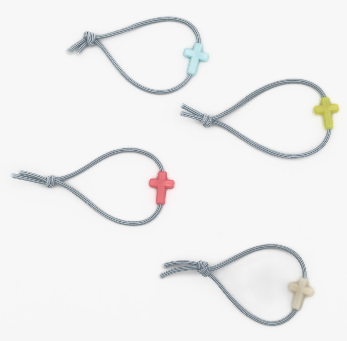 Four grey children's bracelets with cross-shaped silicone beads in various colours