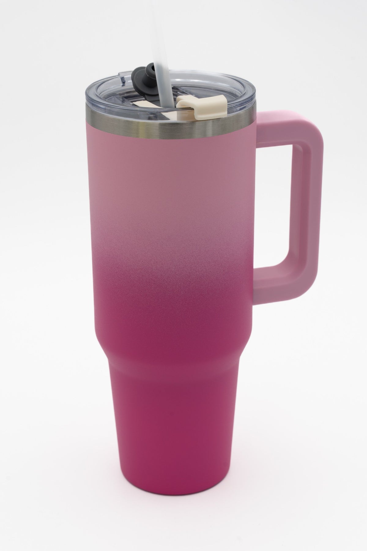 Insulated tumbler with a light pink-to-fuchsia gradient, handle and transparent lid