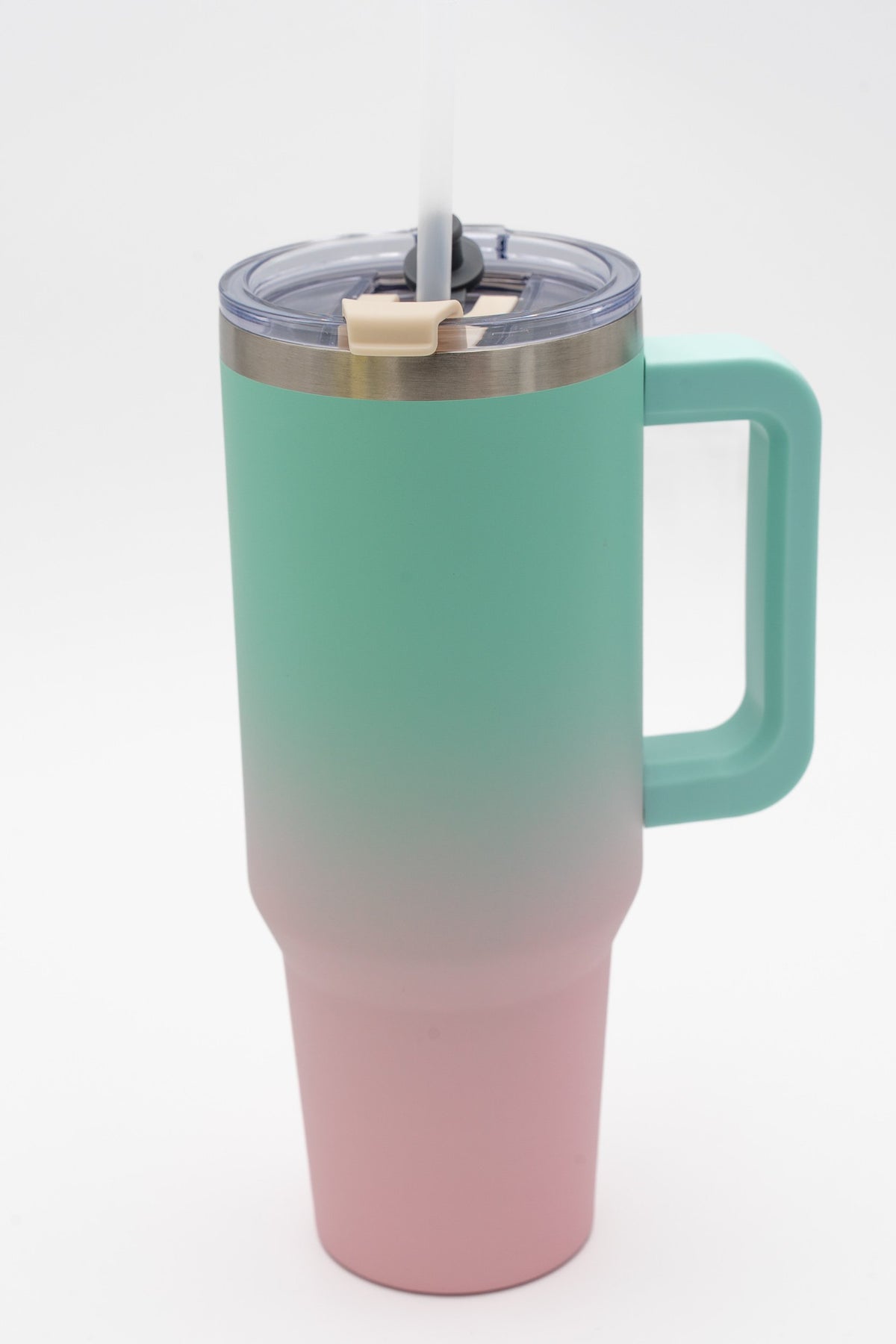 Travel tumbler with a turquoise-to-pastel-pink gradient, handle and straw
