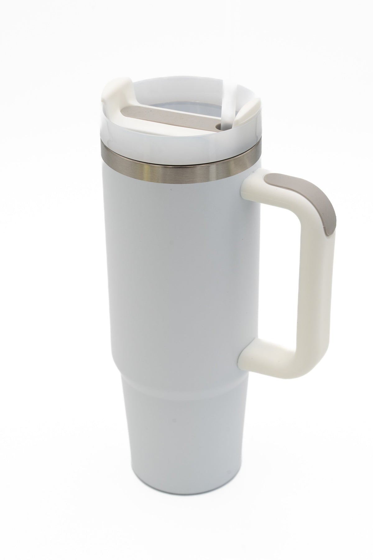 White travel tumbler with an ergonomic handle and lid opening for a straw