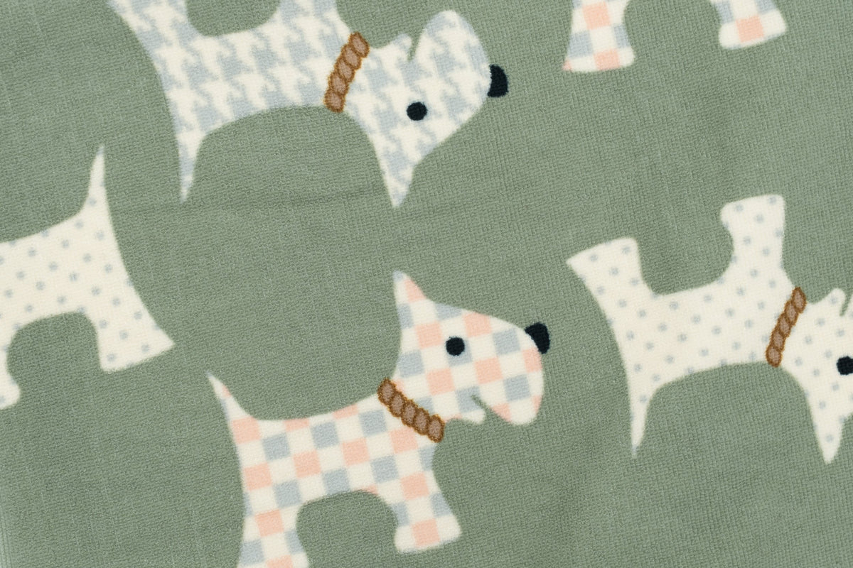 Close-up of an olive-green towel with a pastel puppy print.