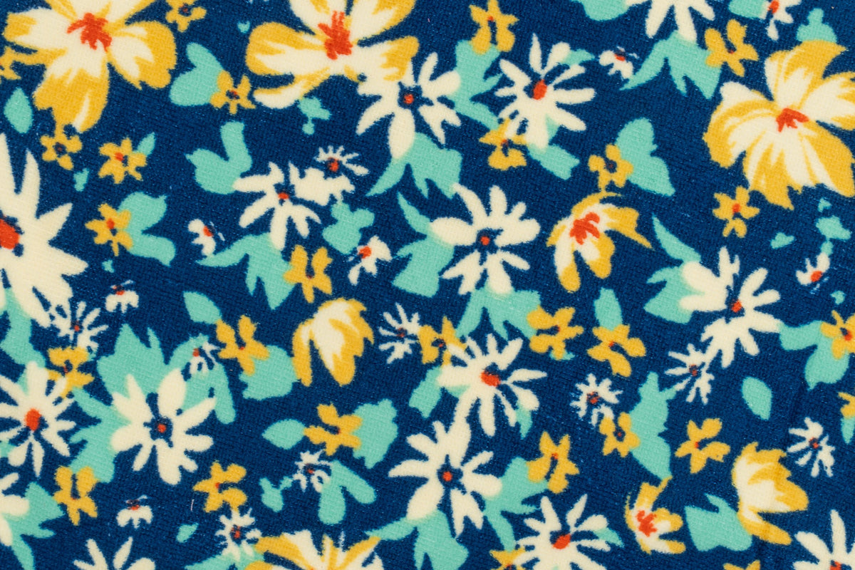 Close-up of a navy blue towel with printed white and yellow flowers.