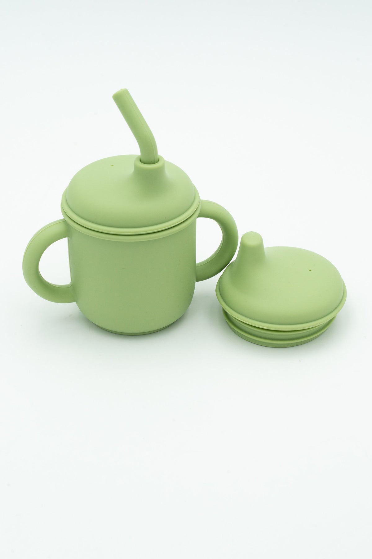 Green cup with a straw and spout lid for drinking